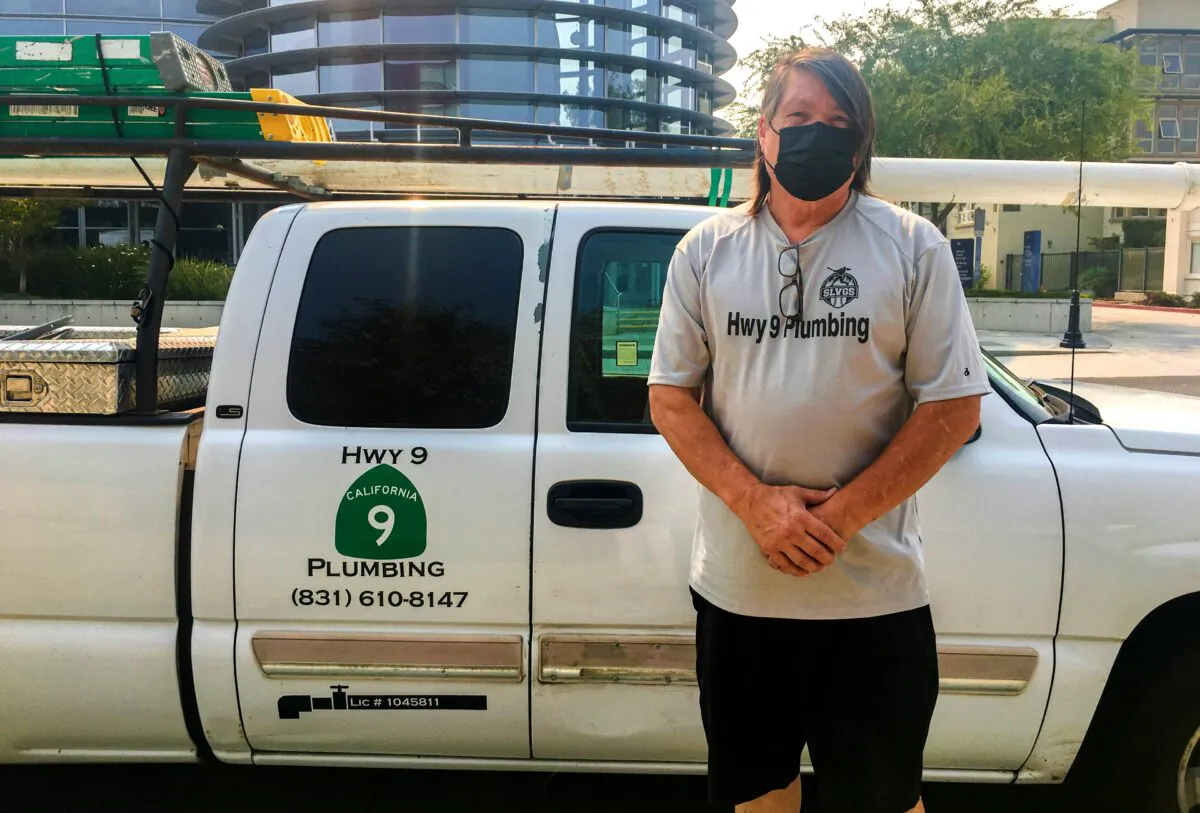 Greg Oropeza stands outside the Milpitas Library, which is acting as a resource center for wildfire evacuees, in Milpitas, Calif., on Aug. 24, 2020. (Ilene Eng/The Epoch Times)
