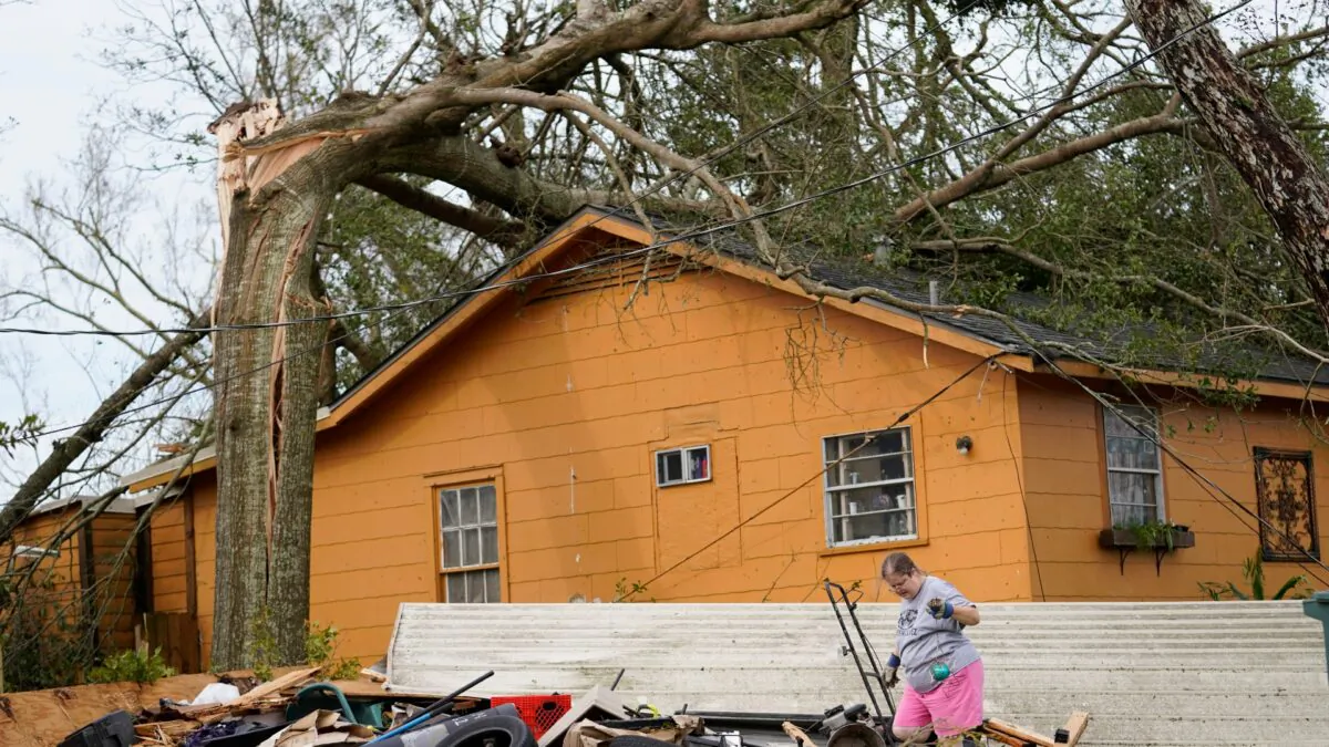 Hollie Moore walks through debris at her home in Lake Charles, La., in the aftermath of Hurricane Laura in Lake Charles, La., on Aug. 27, 2020. (Gerald Herbert/AP Photo)