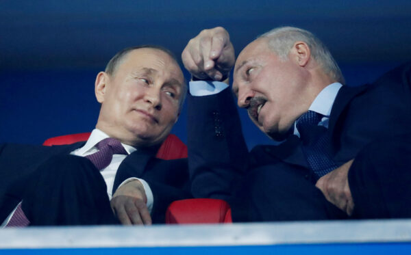 Vladimir Putin and Alexander Lukashenko speak in the stands during the closing ceremony in Dinamo Stadium