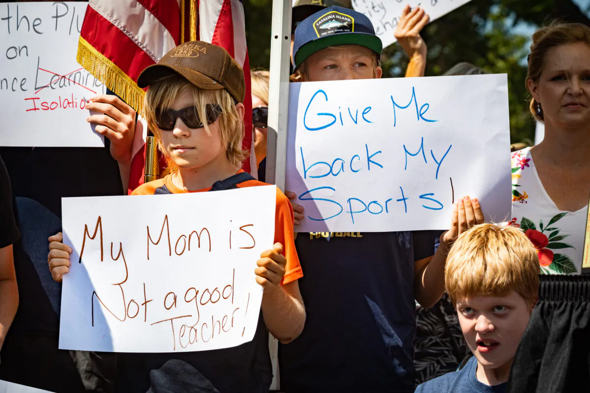 Parents and students gather at a protest supporting a lawsuit calling for the immediate reopening of schools in front of the Orange County Department of Education building in Costa Mesa, Calif., on Aug. 26, 2020. (John Fredricks/The Epoch Times)

