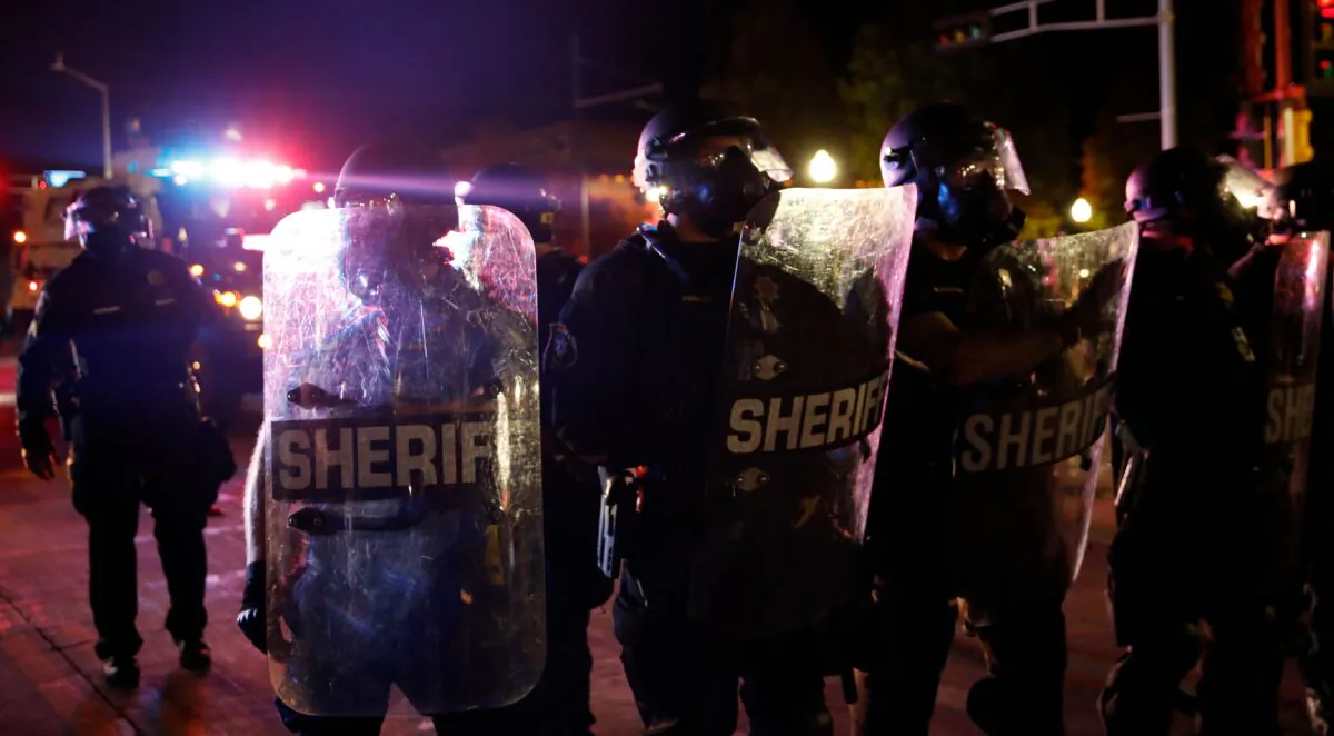 Sheriff and police in riot gear face off with protestors outside the County Courthouse during demonstrations against the shooting of Jacob Blake in Kenosha, Wis. on Aug. 25, 2020. (Kamil Krzaczynski/AFP via Getty Images)