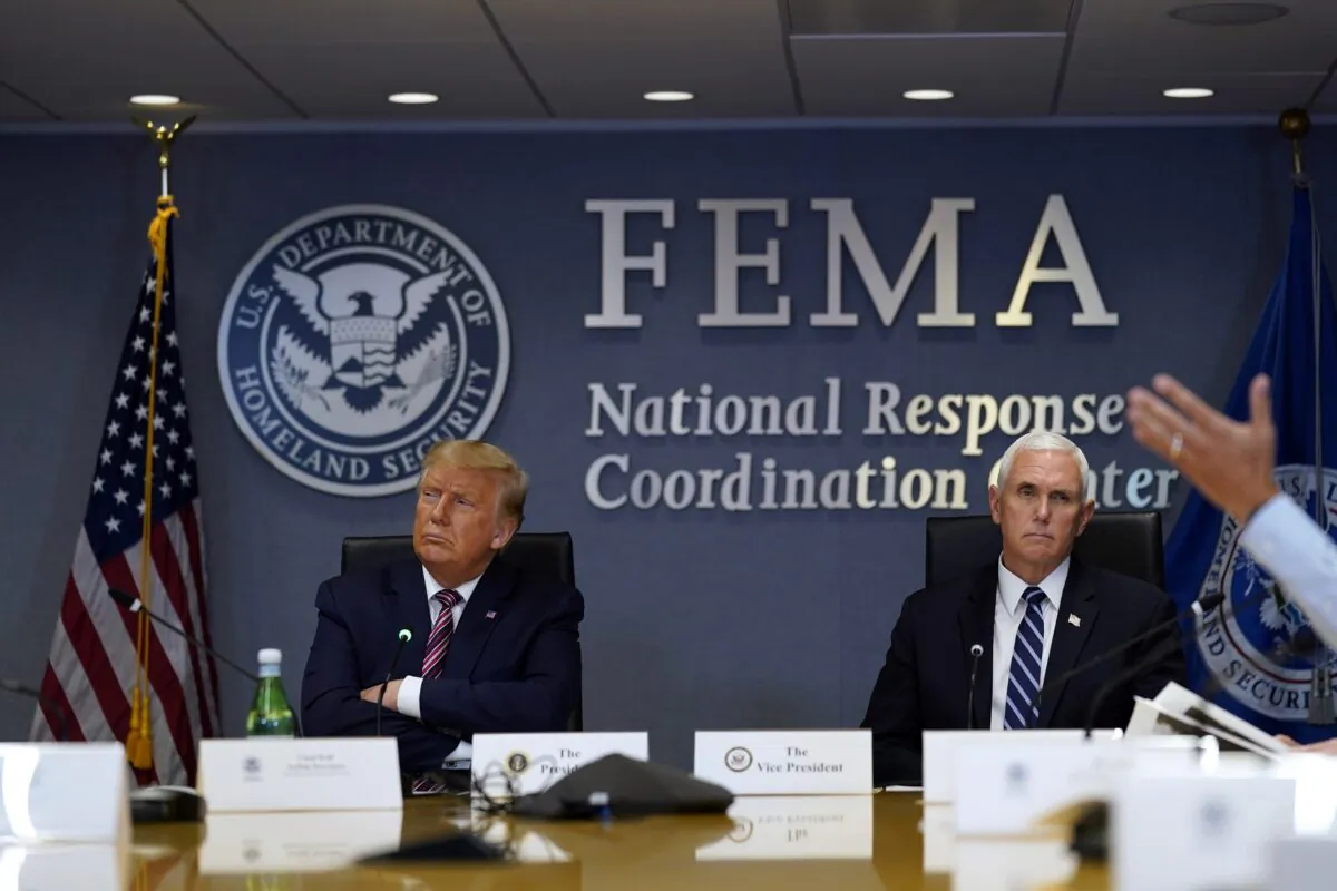 President Donald Trump and Vice President Mike Pence listen during a Hurricane Laura briefing at FEMA headquarters in Washington on Aug. 27, 2020. (Evan Vucci/AP Photo)