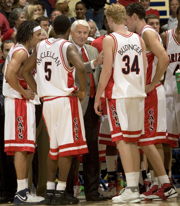 Lute Olson, center, talks to his players during the second half of a college basketball game