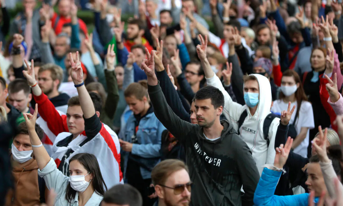 People gesture during a protest at the Independence Square in Minsk on Aug. 27, 2020. (Sergei Grits/AP)