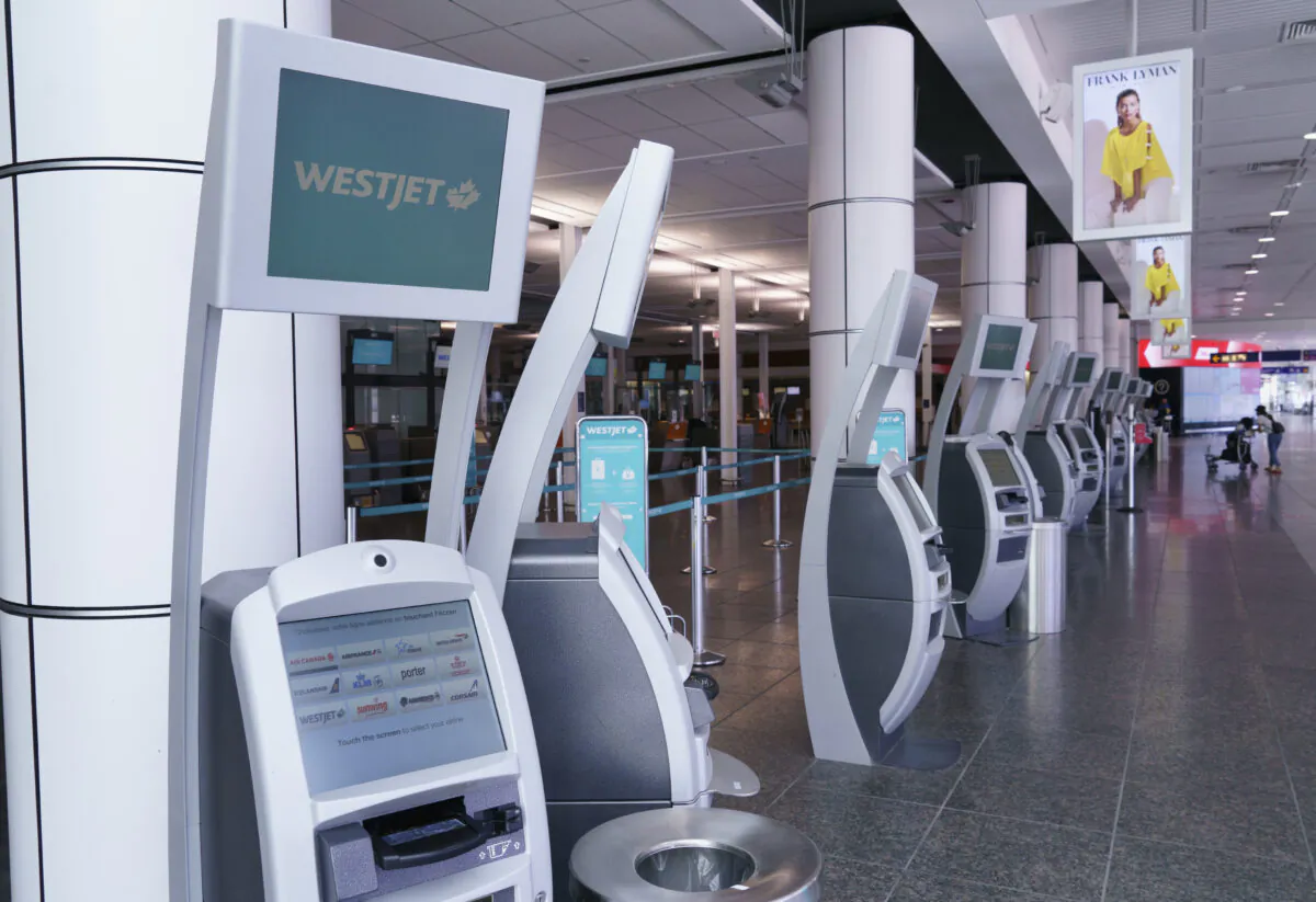 WestJet self-service check-in kiosks are seen at Montreal-Trudeau International Airport on July 31, 2020. (The Canadian Press/Paul Chiasson)