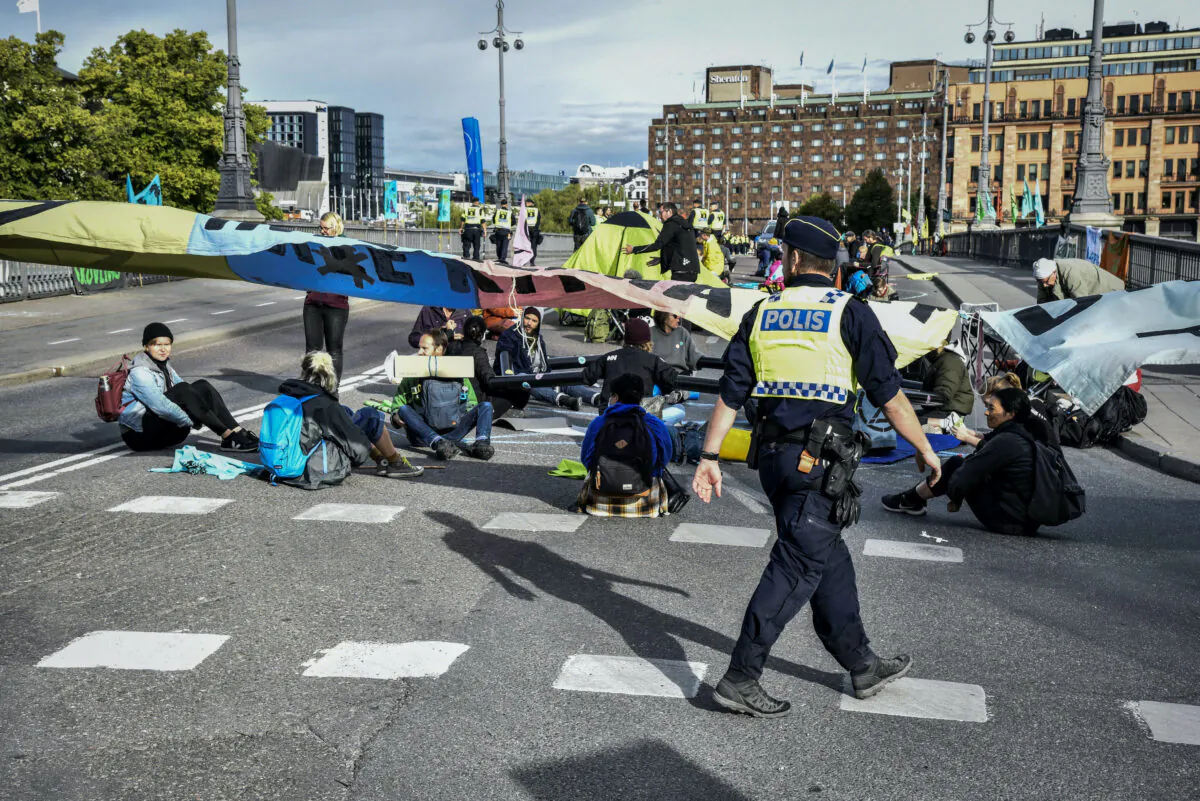 Climate change activists of Extinction Rebellion block the traffic at a bridge in central Stockholm on Aug. 28, 2020. (TT News Agency/Lars Schroder via Reuters)