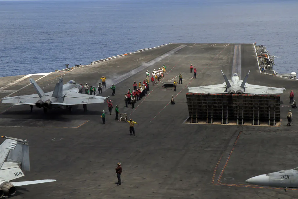 US Navy F/A-18 Super Hornets multirole fighters prepare to take off from the flight deck of USS Ronald Reagan (CVN-76) aircraft carrier on Oct. 16, 2019, as it sails in the South China Sea on its way to Singapore. (Catherine Lai/AFP via Getty Images)