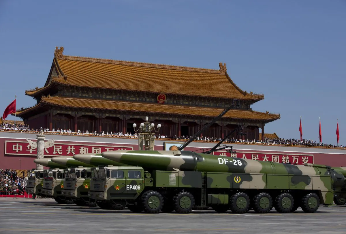 Chinese military vehicles, carrying DF-26 ballistic missiles, drive past Tiananmen Square during a military parade in Beijing on Sept. 3, 2015. (Andy Wong/Pool/Getty Images)