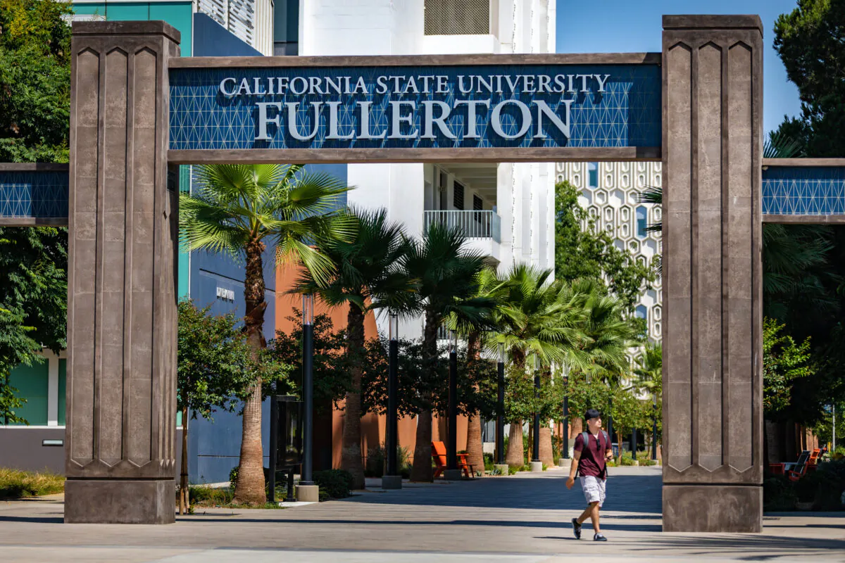 A student walks under the entry to the California State University–Fullerton campus in Fullerton, Calif., on Aug. 28, 2020. (John Fredricks/The Epoch Times)