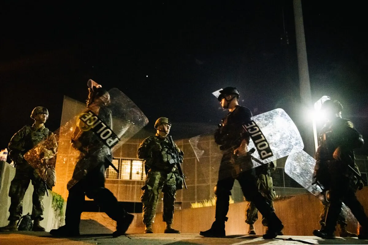 National Guard troops stand guard inside of a fenced area that surrounds several government buildings in Kenosha, Wis., on Aug. 27, 2020. (Brandon Bell/Getty Images)