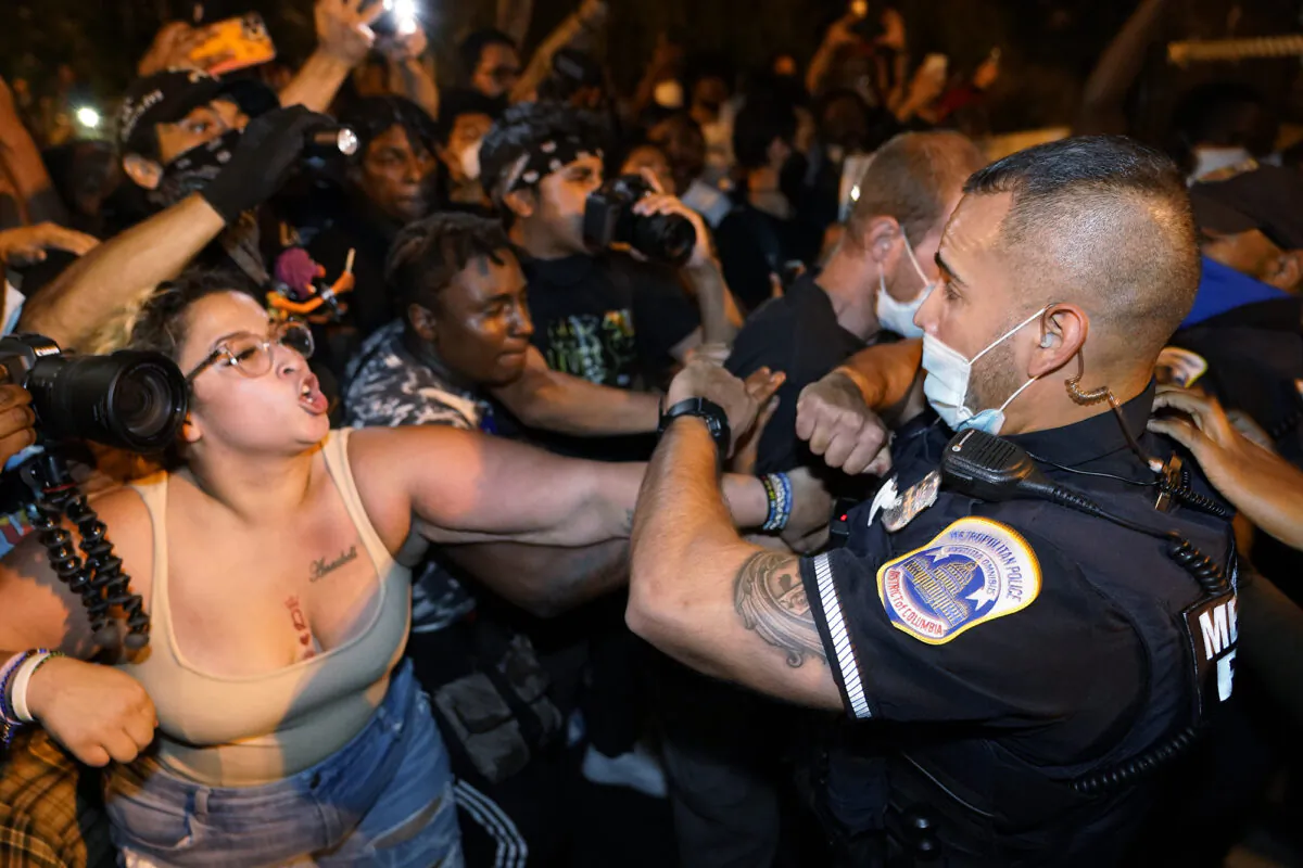 Demonstrators clash with police officers in Washington on Aug. 27, 2020. (Julio Cortez/AP Photo)