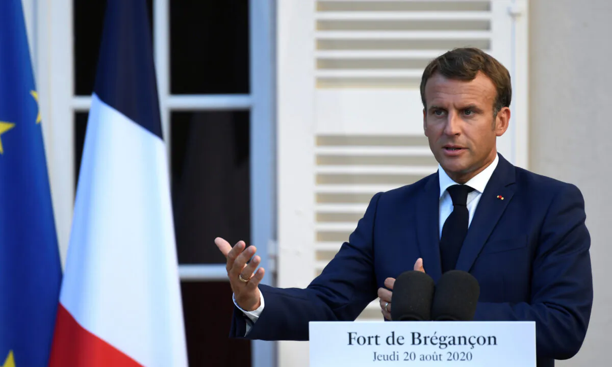 French President Emmanuel Macron speaks at the press conference at in Bormes-les-Mimosas, France on Aug. 20, 2020. (Christophe Simon/Pool via Reuters)
