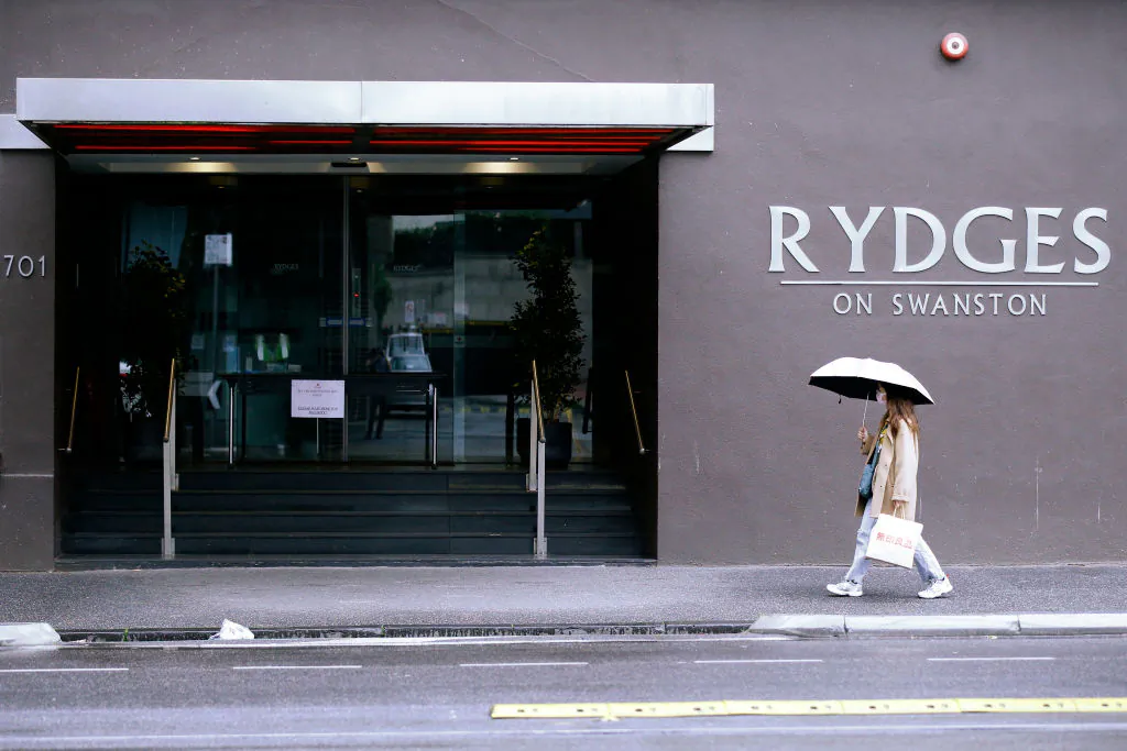 A women wearing a face mask walks past the Rydges Hotel in Carlton in Melbourne, Australia on June 25, 2020. (Darrian Traynor/Getty Images)