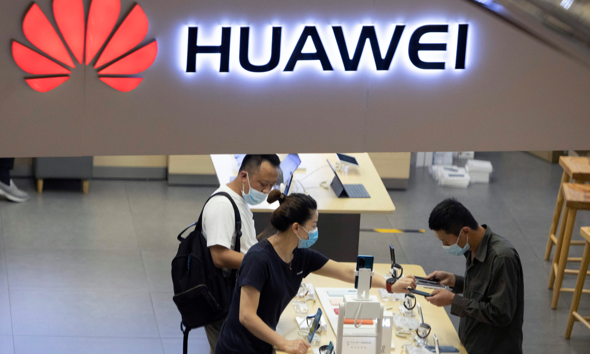 Visitors look at the latest products at a Huawei store in Beijing
