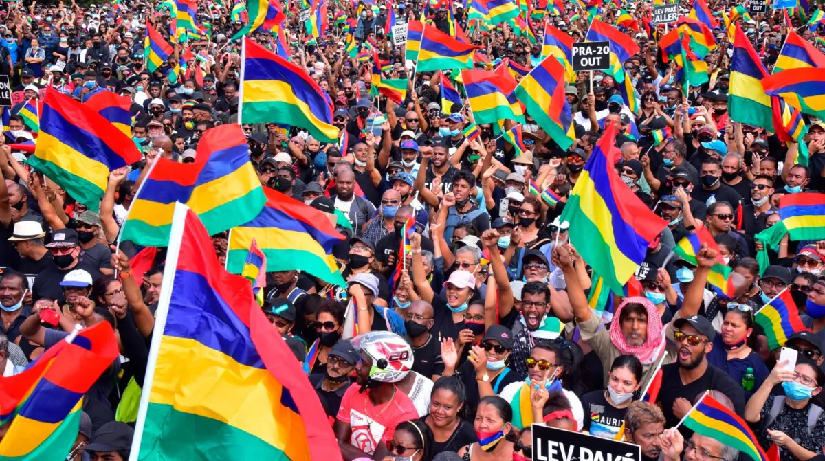 Tens of thousands of people protest in Port Louis, Mauritius, Sat. Aug. 29, 2020, over the government's slow response to an oil spill from a grounded Japanese ship and the alarming discovery of dozens of dead dolphins. (Beekash Roopun/L'express Maurice via AP)