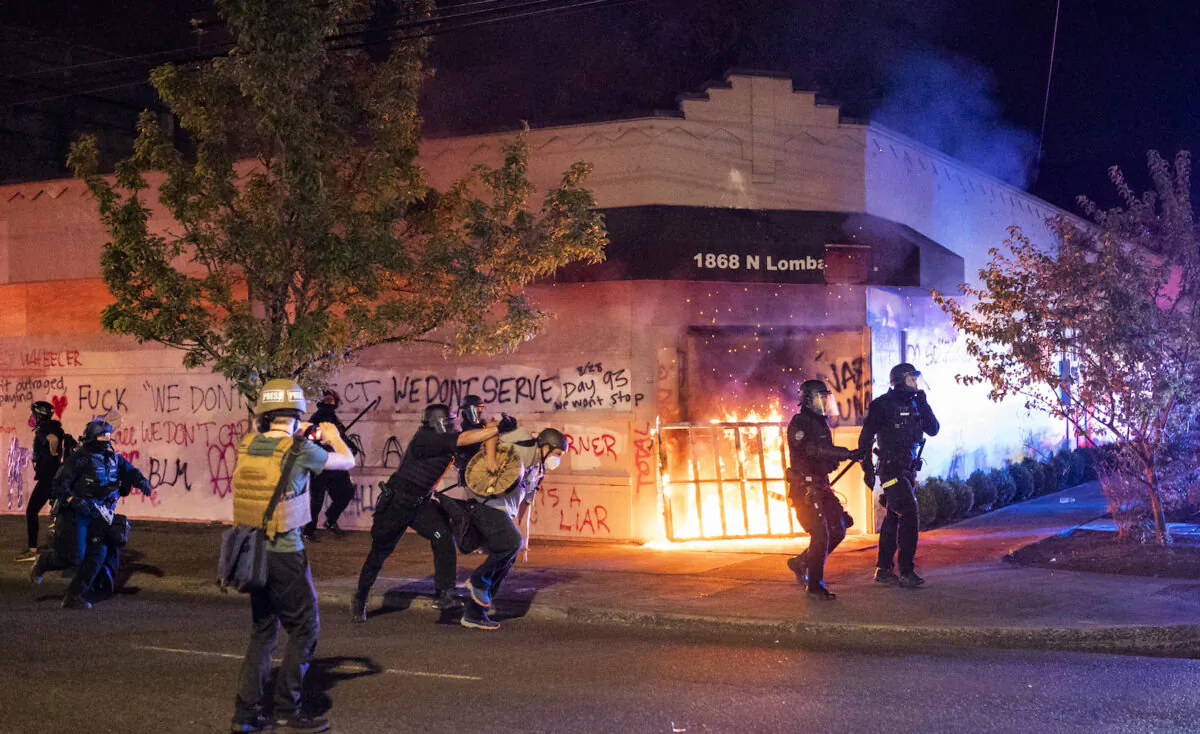 Portland police disperse a crowd after rioters set fire to the Portland Police Association building early in the morning in Portland, Ore., on Aug. 29, 2020. (Nathan Howard/Getty Images)