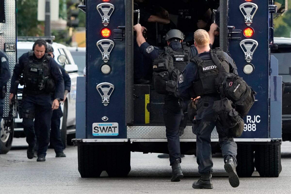 Police work near the scene of a shooting in St. Louis