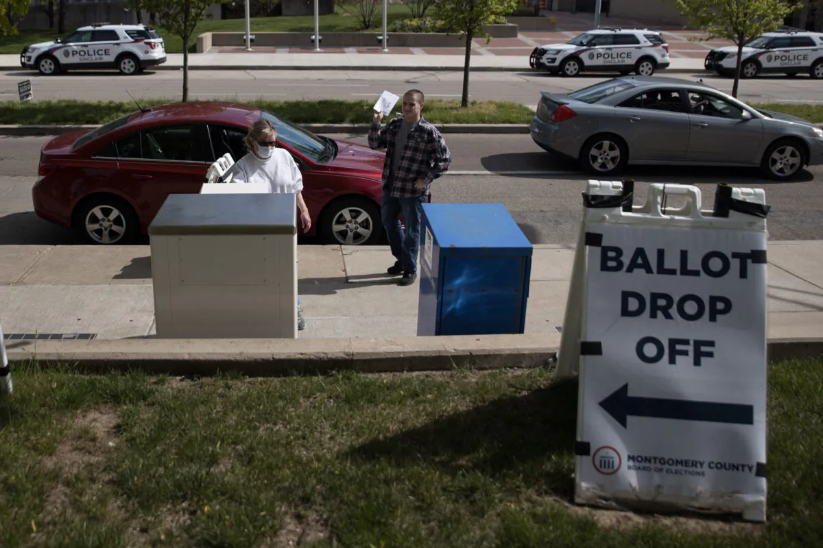 Ohio voters drop off their ballots at the Board of Elections in Dayton, Ohio, on April 28, 2020.  (MEGAN JELINGER/AFP via Getty Images)