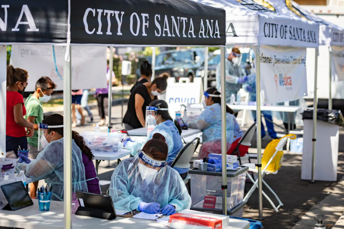 Medical staff work at a Santa Ana CARES mobile resource center for COVID-19-related outreach in vulnerable communities of Santa Ana, Calif., on Aug. 26, 2020. (John Fredricks/The Epoch Times)