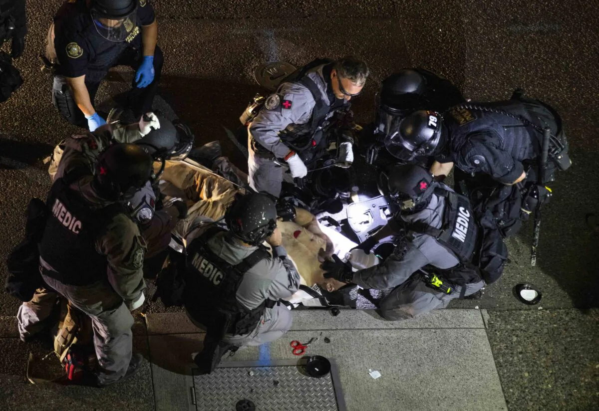 A man is treated by medics after being shot during a confrontation in Portland, Ore., on Aug. 29, 2020. (Paula Bronstein/AP Photo)