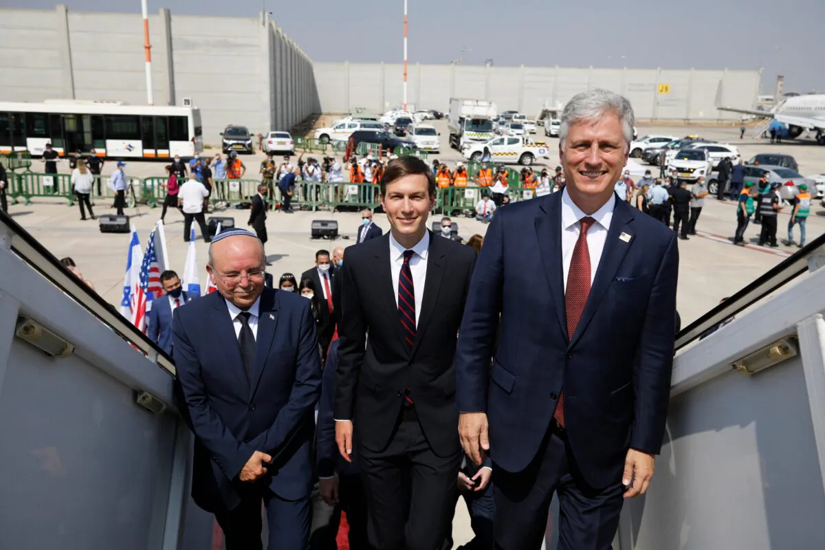 Israeli National Security Adviser Meir Ben-Shabbat, left, U.S. President Donald Trump's senior adviser Jared Kushner, center, and U.S. National Security Advisor Robert O'Brien, right, board the Israeli flag carrier El Al's airliner as they fly to Abu Dhabi for talks meant to put final touches on the normalization deal between the United Arab Emirates and Israel, at Ben-Gurion International Airport, near Tel Aviv, Israel, on Aug. 31, 2020. (Nir Elias/Pool Photo via AP)