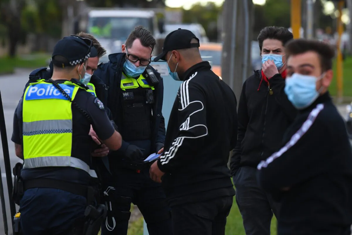 Victorian Police take the details of a man in Dandenong, Melbourne, Aug. 27, 2020. (AAP Image/James Ross)