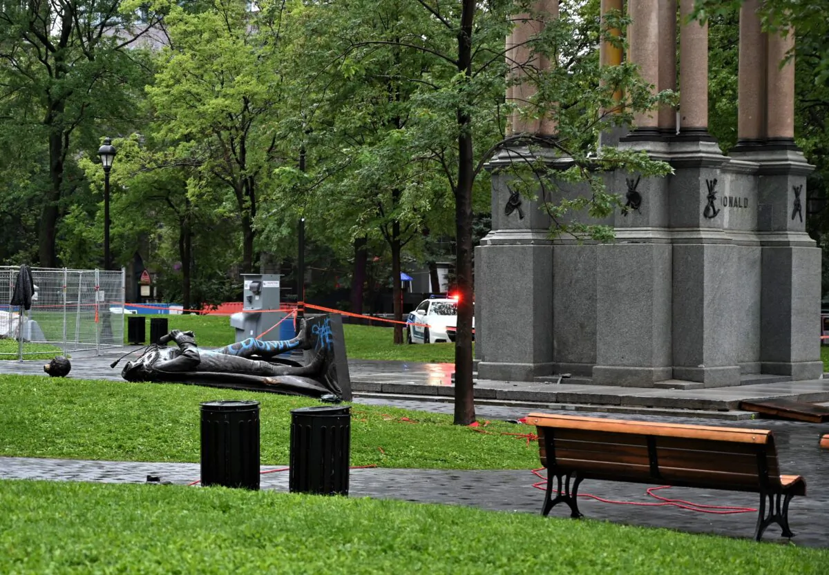 The statue of Sir John A. Macdonald lies on the ground, with its head a few metres away, at Place du Canada in Montreal after it was torn down by activists on Aug. 29, 2020. (Eric Thomas/AFP via Getty Images)