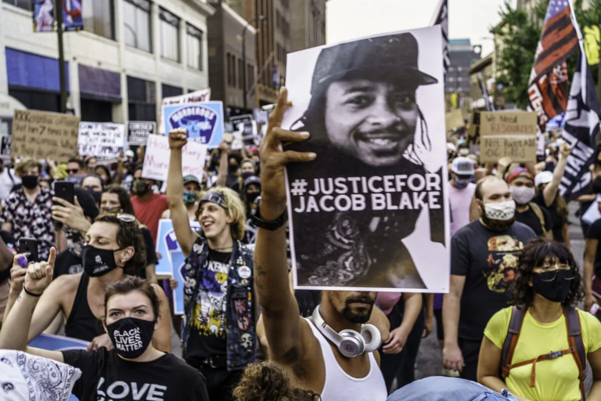 Protesters march near the Minneapolis 1st Police precinct in Minneapolis, Minn., on Aug. 24, 2020. (Kerem Yucel/AFP via Getty Images)