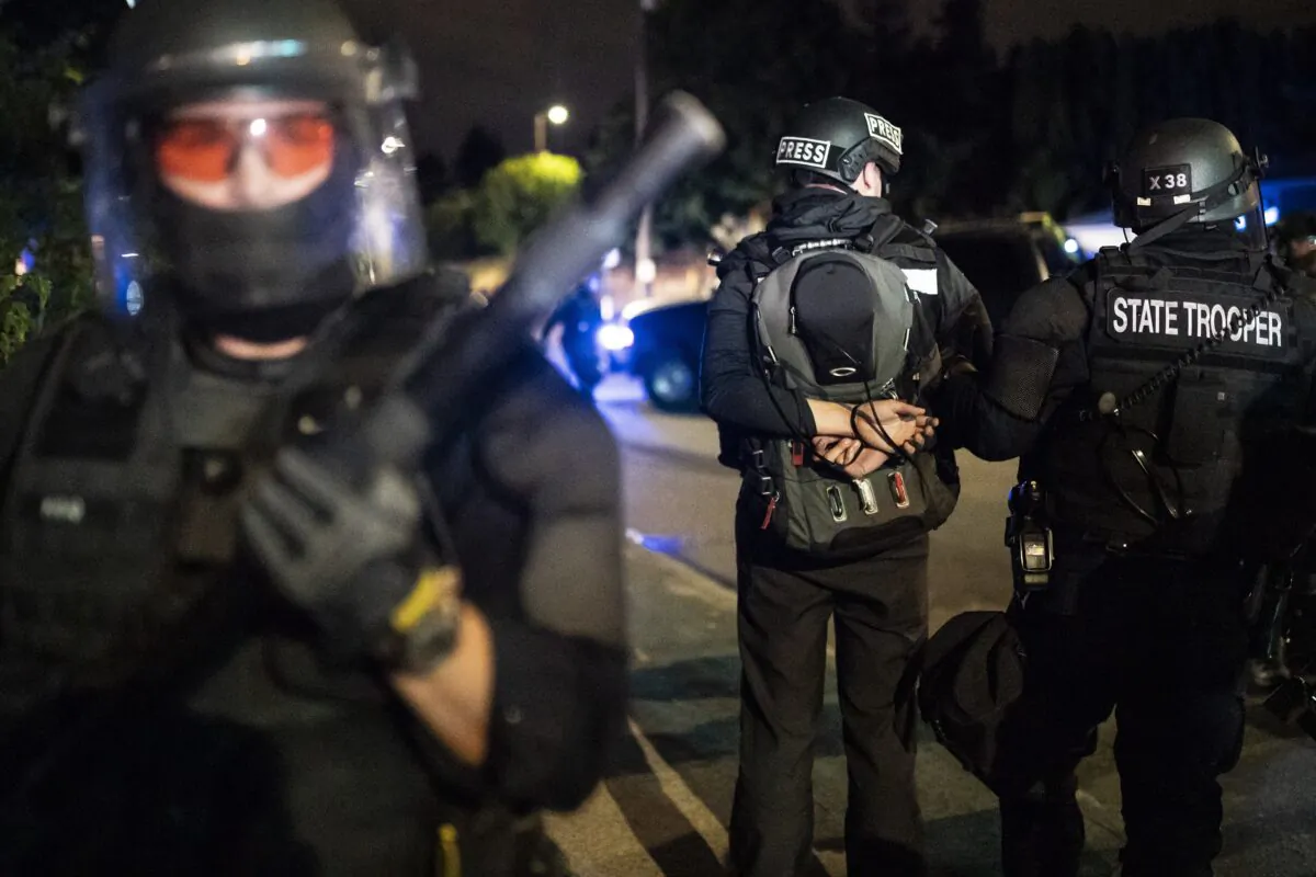An Oregon State Trooper makes an arrest while dispersing a violent demonstration in Portland, Ore., on Aug. 30, 2020. (Nathan Howard/Getty Images)