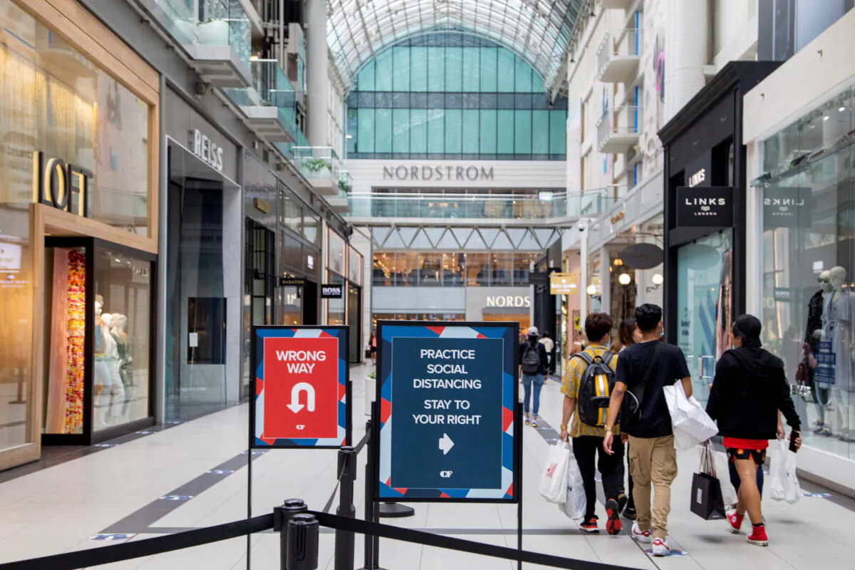 People walk in the Eaton Centre shopping mall after the provincial phase 2 of reopening from COVID-19 restrictions began in Toronto on June 24, 2020. (REUTERS/Carlos Osorio/File Photo)