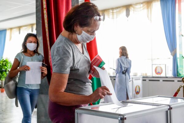 A woman casts her ballot at a polling station