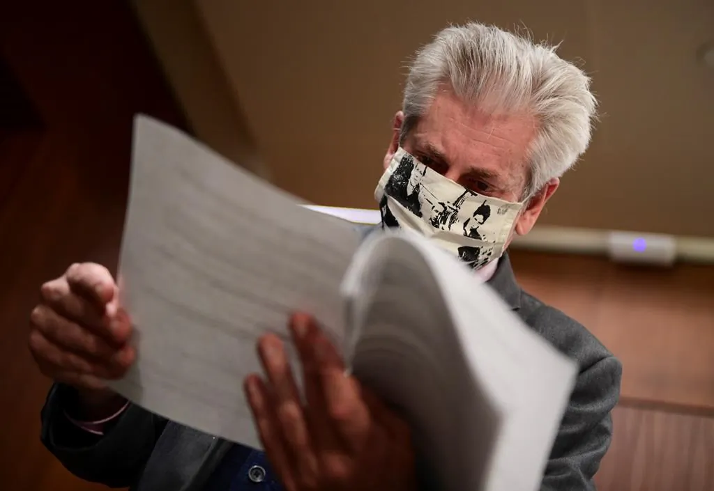 NDP MP Charlie Angus speaks to reporters as he thumbs through a document following a press conference on Parliament Hill in Ottawa on Sept. 1, 2020. (Sean Kilpatrick/The Canadian Press)