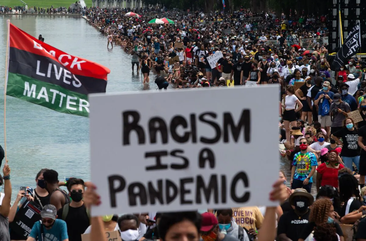 Protesters fly Black Lives Matter flags in support of the movement during the Commitment March, organized by Rev. Al Sharpton, in Washington on Aug. 28, 2020. (Roberto Schmidt/AFP via Getty Images)