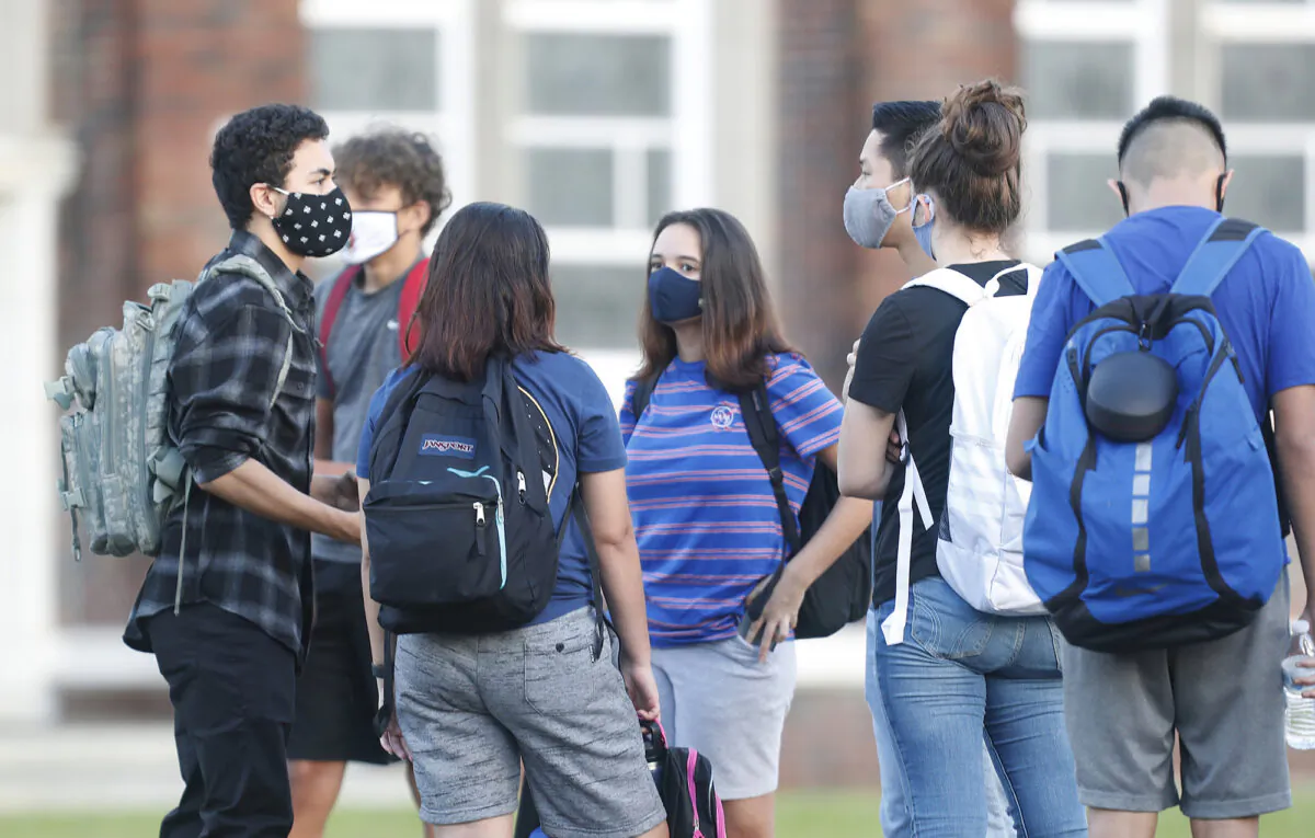 High school students in line to have temperature checked before entering the building in Tampa, Fla., on Aug. 31, 2020. (Octavio Jones/Getty Images)