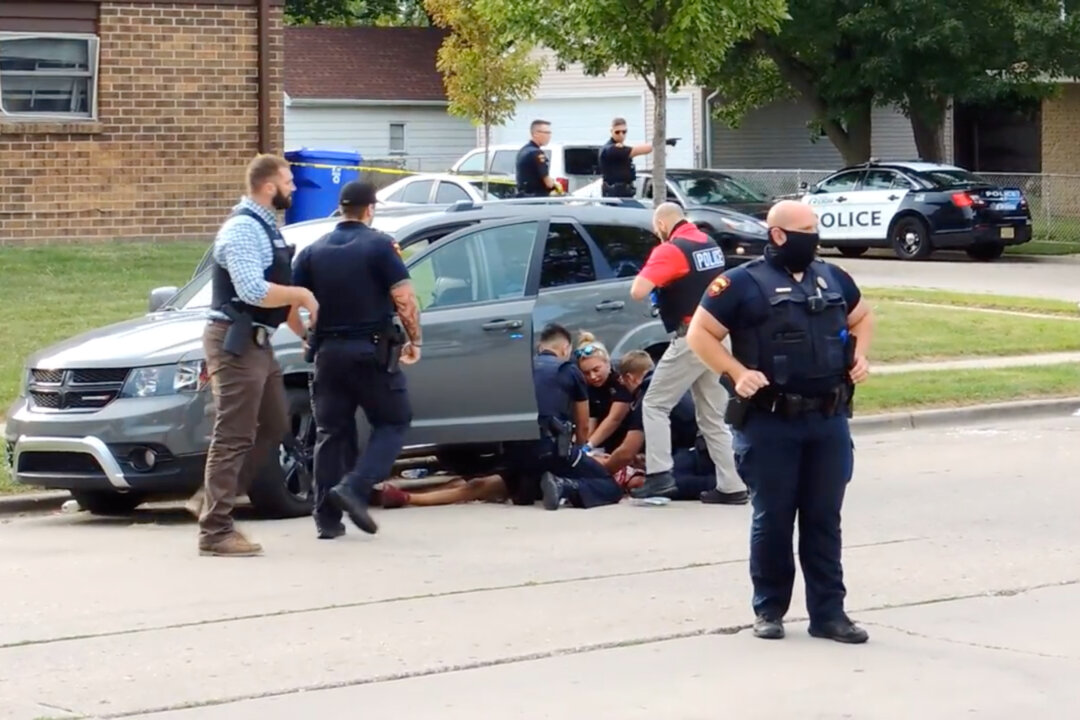 In this screen grab obtained from a social media video, Jacob Blake lies on the street after he got shot by a police officer after resisting arrest in Kenosha, Wisc., on Aug. 23, 2020. (Incident Response/via Rreuters)