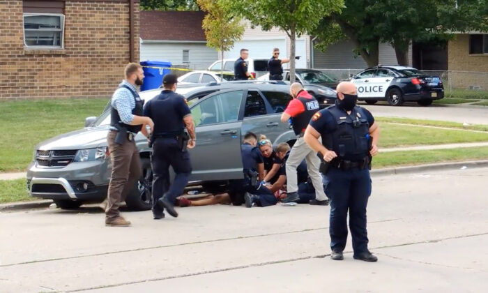 In this screen grab obtained from a social media video, Jacob Blake lies on the street after he got shot by a police officer after resisting arrest in Kenosha, Wisc., on Aug. 23, 2020. (Incident Response/via Rreuters)