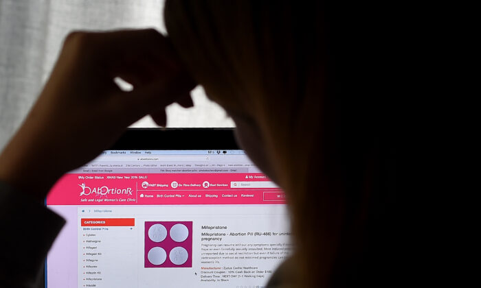 A woman looks at an abortion pill (RU-486) displayed on a computer in Arlington, Va., on May 8, 2020. (Olivier Douliery/AFP via Getty Images)