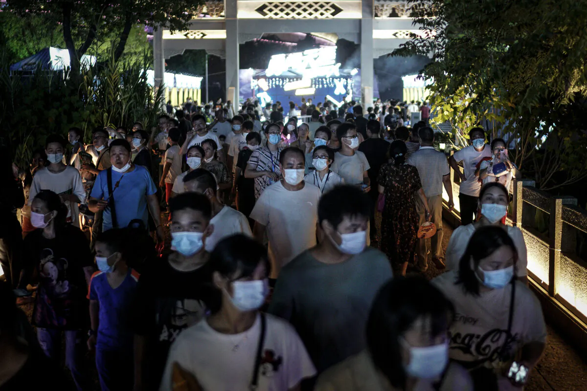 Residents wear masks while walking through the entrance of the Wuhan Beer Festival in Wuhan city, Hubei Province, China, on August 21, 2020. (Getty Images)