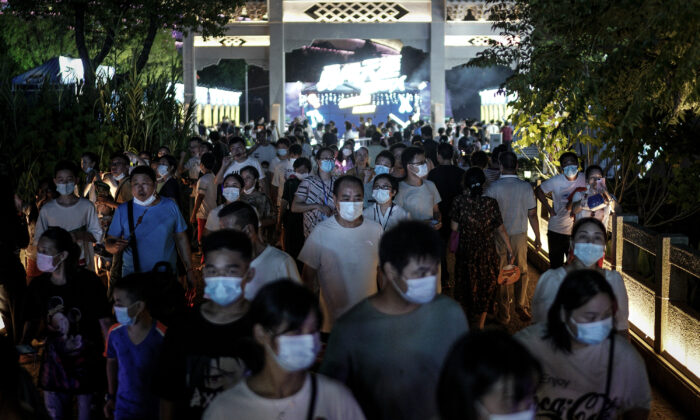 Residents wear masks while walking through the entrance of the Wuhan Beer Festival in Wuhan city, Hubei Province, China, on August 21, 2020. (Getty Images)