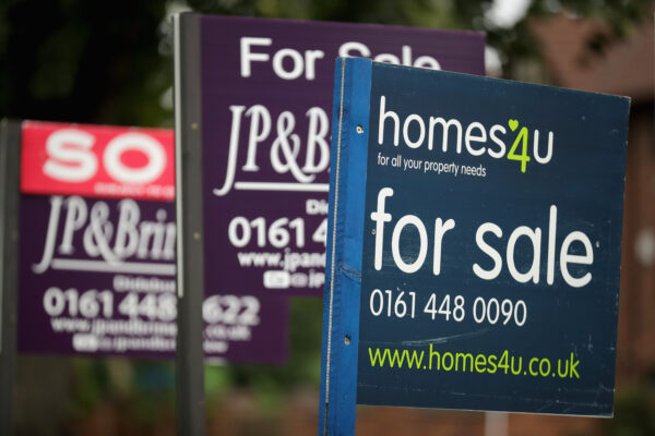 For Sale boards stand outside homes in Didsbury in Manchester, England