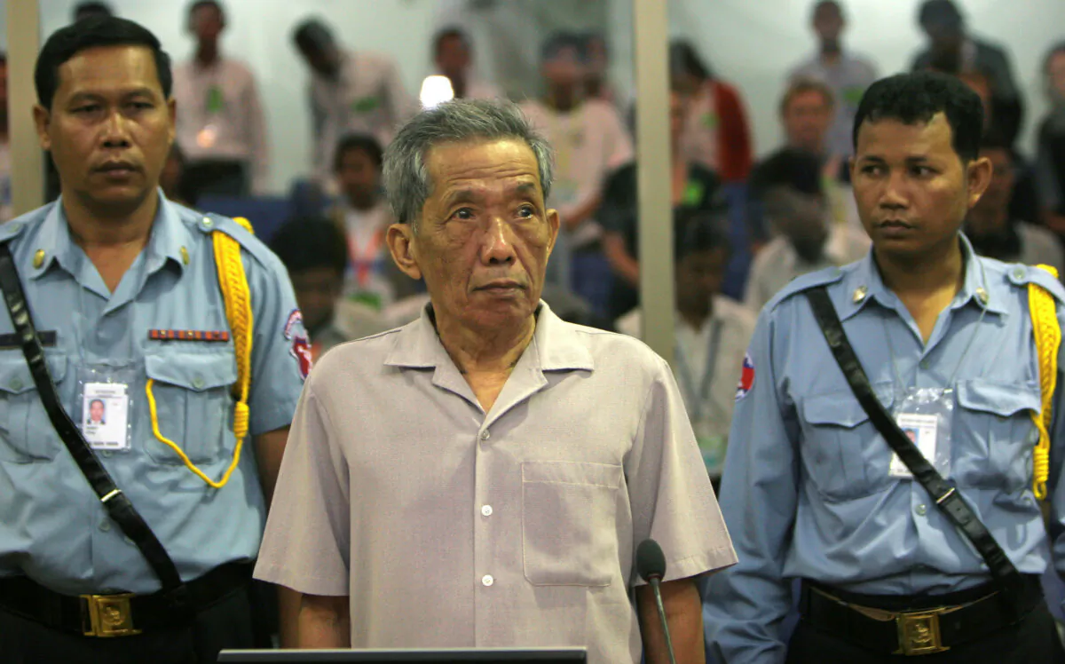 Former Khmer Rouge S-21 prison chief Kaing Guek Eav, better known as Duch, stands in a courtroom during a pre-trial in Phnom Penh on Dec. 5, 2008. (Tang Chhinsothy/Pool (CAMBODIA)/Reuters)