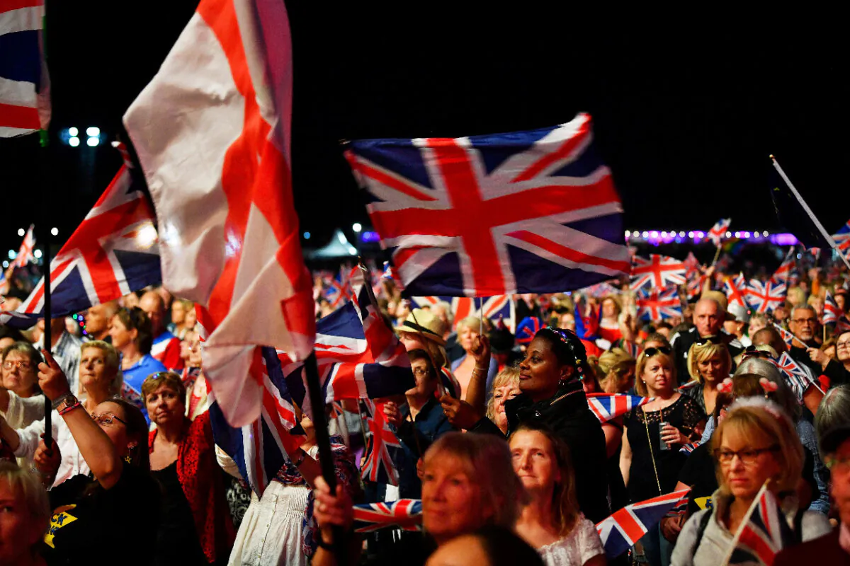 In this file photo, revelers wave British flags as they enjoy The Last Night of the Proms celebration in Hyde Park, London, on Sept. 14, 2018. (Reuters/Dylan Martinez)