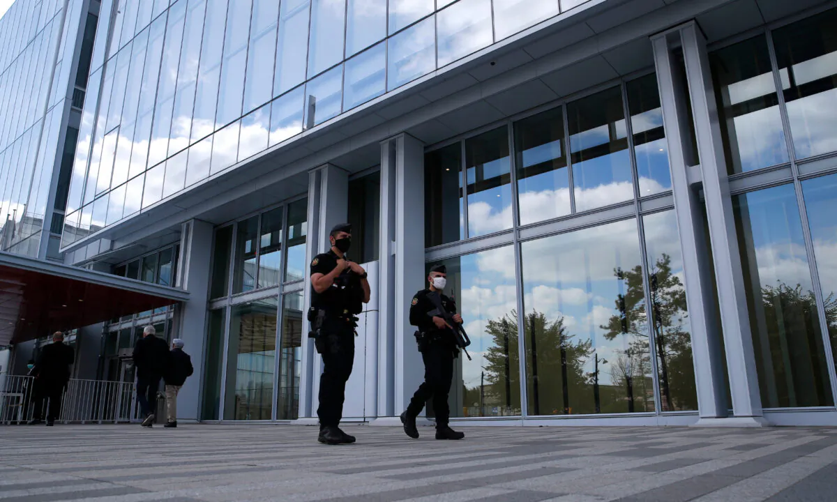Police officers patrol outside the courthouse during the opening of the 2015 attacks trial in Paris on Sept. 2, 2020. (Francois Mori/AP Photo)