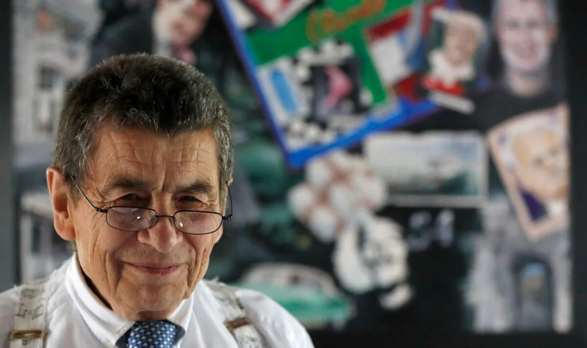 Human rights lawyer Sir Geoffrey Nice QC stands in front of a picture collage of himself that a friend had made at his home in Adisham, England, on Sept. 2, 2020. (Frank Augstein/AP Photo)