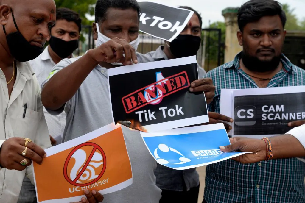 Members of the City Youth Organisation hold posters with logos of Chinese apps in support of the Indian government for banning the wildly popular video-sharing TikTok app, in Hyderabad, India, on June 30, 2020. (Noah Seelam/AFP via Getty Images)