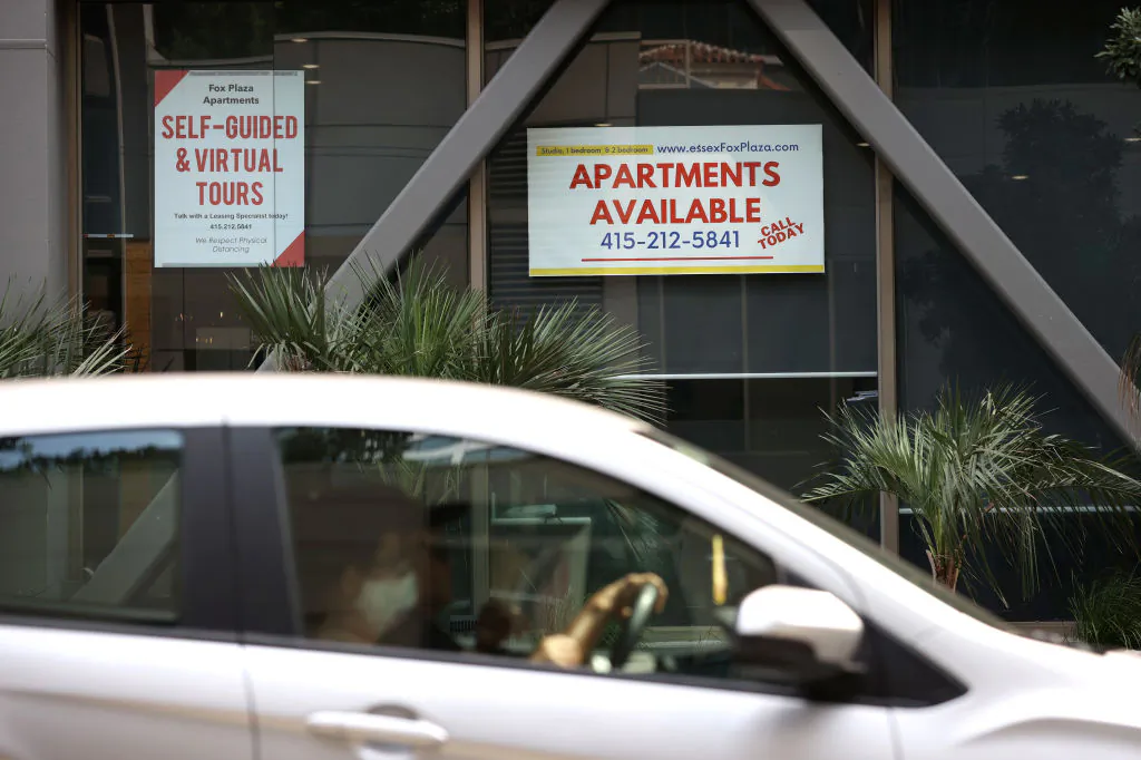 A car drives by a building advertising apartment leases in San Francisco on Sept. 1, 2020. (Justin Sullivan/Getty Images)