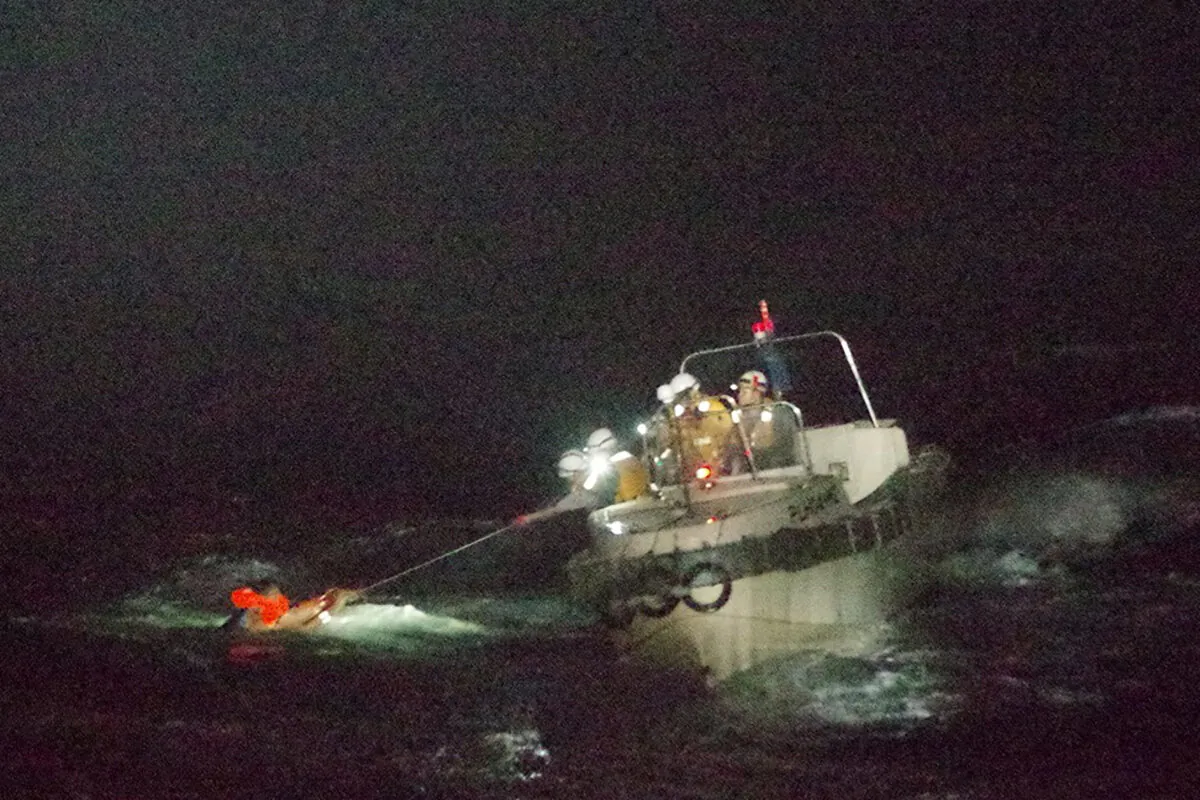 In this photo released by the 10th Regional Japan Coast Guard Headquarters, a Filipino crewmember of a Panamanian cargo ship is rescued by Japanese Coast Guard members in the waters off the Amami Oshima, Japan Wednesday, Sept. 2, 2020. (The 10th Regional Japan Coast Guard Headquarters via AP)