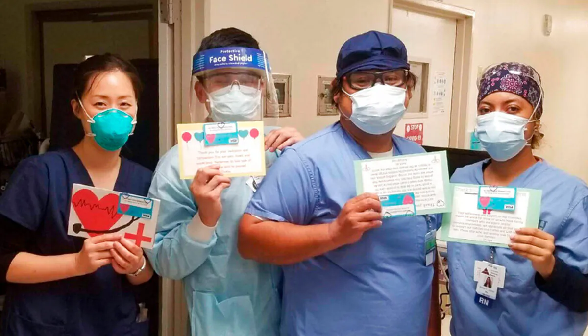 Health care workers hold thank-you cards from the "Cards 4 COVID Heroes" initiative at Los Angeles Community Hospital in Los Angeles on June 30, 2020. (Keith Levy via AP)