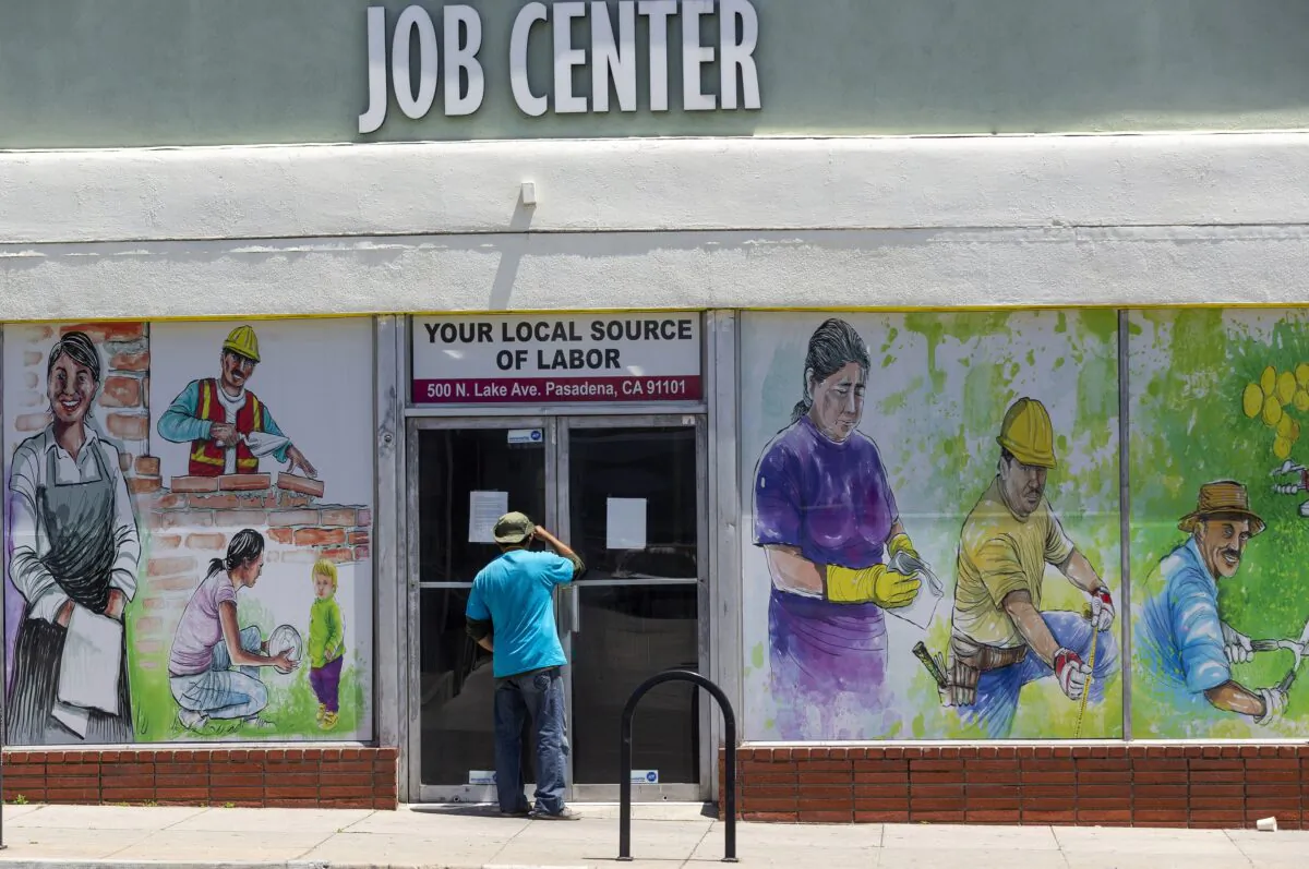 A person looks inside the closed doors of the Pasadena Community Job Center in Pasadena, Calif., on May 7, 2020. (Damian Dovarganes/AP Photo)