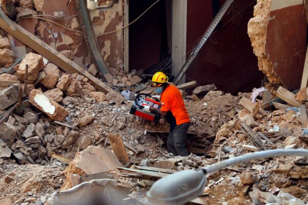 A Chilean rescuer holds a signal detected machine